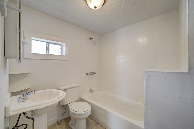 5120 Leeland St, Houston, TX 77023 - bathroom with toilet, shower / bath combination, a textured ceiling, tile patterned flooring, and baseboards