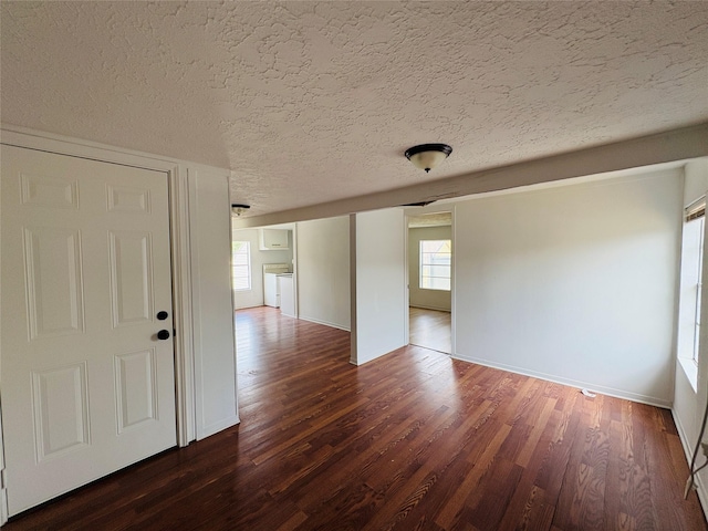 5120 Leeland St, Houston, TX 77023 - empty room featuring dark wood-style floors, a textured ceiling, and baseboards