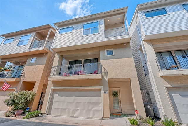 804 Paige St, Houston, TX 77003 - townhome / multi-family property featuring stucco siding, an attached garage, a balcony, and concrete driveway