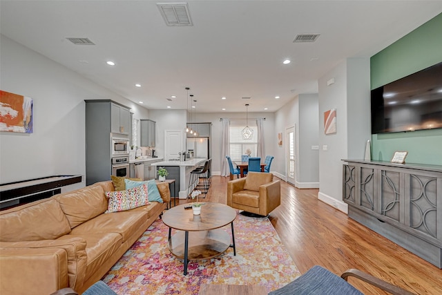 804 Paige St, Houston, TX 77003 - living room with light wood-type flooring, baseboards, and recessed lighting