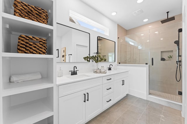 1428 Miller St, Houston, TX 77003 - full bathroom featuring a stall shower, double vanity, recessed lighting, marble finish floors, and built in shelves