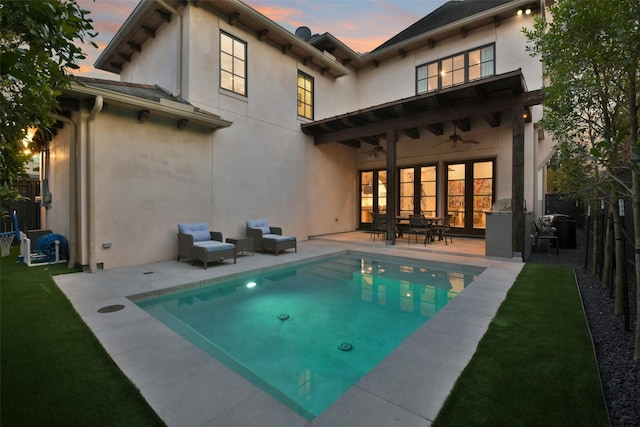2804 Robinhood St, West University Place, TX 77005 - back of house at dusk with a ceiling fan, stucco siding, a patio area, and a fenced backyard