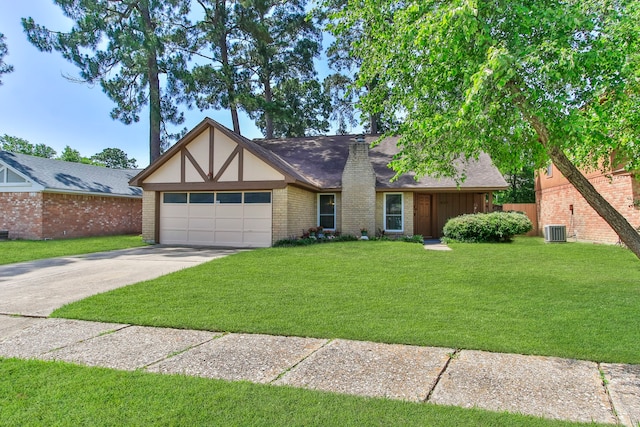 4315 Stallion Brook Ln, Spring, TX 77388 - english style home featuring an attached garage, driveway, a front lawn, and roof with shingles