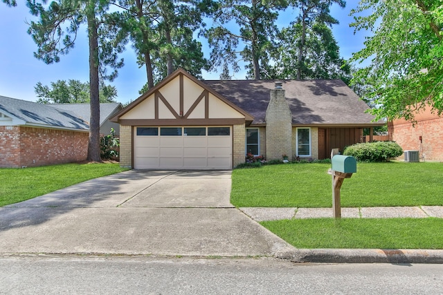 4315 Stallion Brook Ln, Spring, TX 77388 - tudor house featuring a front lawn, an attached garage, concrete driveway, brick siding, and roof with shingles