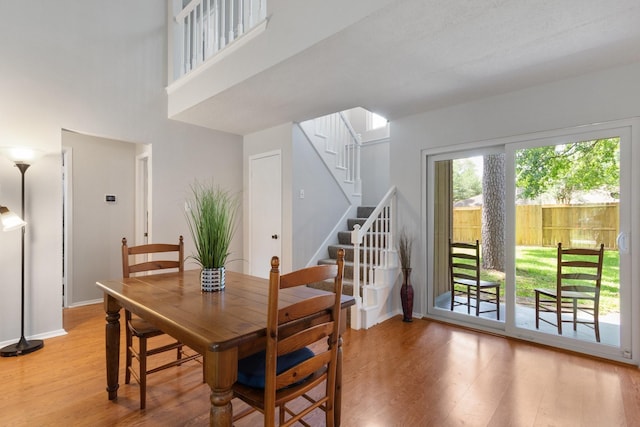 4315 Stallion Brook Ln, Spring, TX 77388 - dining room featuring wood finished floors, stairway, and a towering ceiling