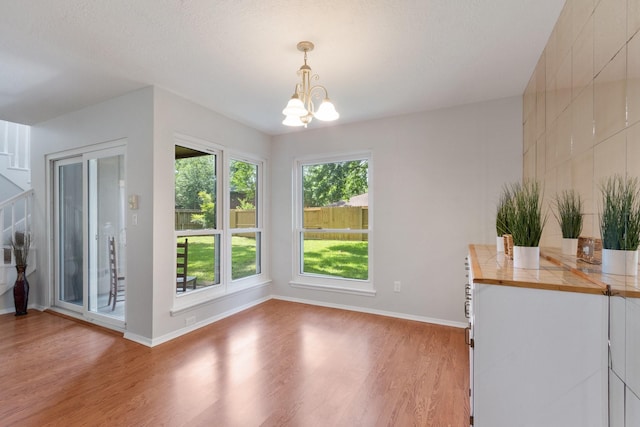 4315 Stallion Brook Ln, Spring, TX 77388 - unfurnished dining area with a chandelier and light wood-style flooring