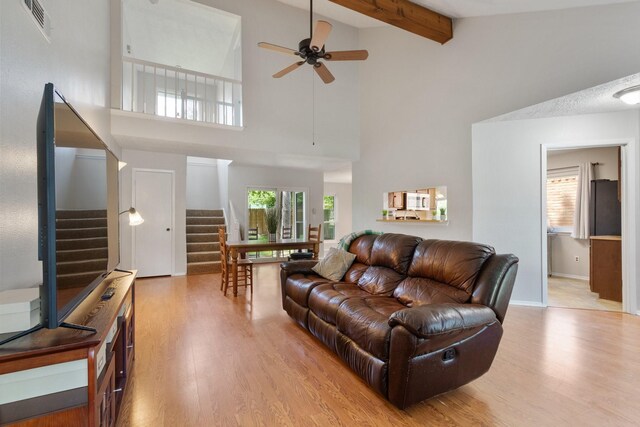 4315 Stallion Brook Ln, Spring, TX 77388 - living room with stairway, a high ceiling, light wood-style flooring, a ceiling fan, and healthy amount of natural light