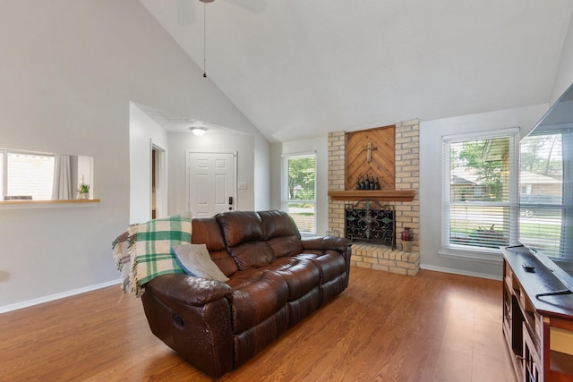 4315 Stallion Brook Ln, Spring, TX 77388 - living area featuring wood finished floors, high vaulted ceiling, a brick fireplace, baseboards, and ceiling fan