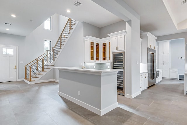 9606 Maribelle Way, Houston, TX 77055 - kitchen featuring high quality fridge, white cabinets, tasteful backsplash, light countertops, and glass insert cabinets