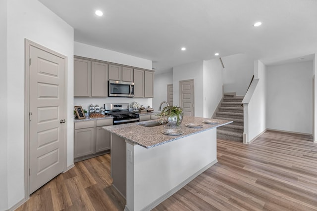 6545 Alexis St, Beaumont, TX 77708 - kitchen with stainless steel appliances, a sink, gray cabinets, an island with sink, and recessed lighting