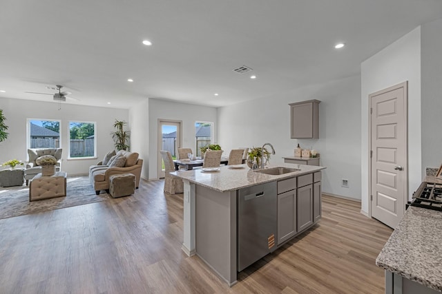 6545 Alexis St, Beaumont, TX 77708 - kitchen with stainless steel dishwasher, a sink, gray cabinetry, open floor plan, and recessed lighting