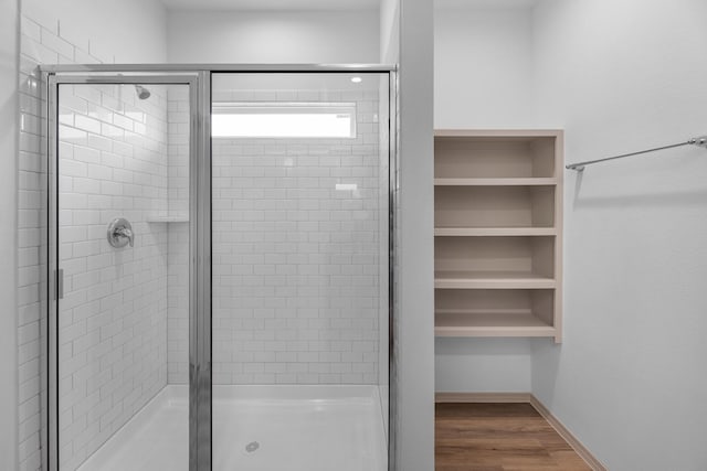 6545 Alexis St, Beaumont, TX 77708 - bathroom with a stall shower, wood finished floors, and a spacious closet