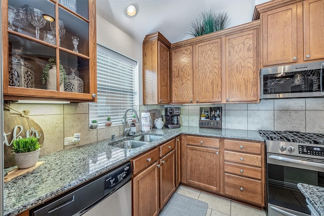 4818 Connor Dr, Baytown, TX 77521 - kitchen with stainless steel appliances, a sink, stone counters, and backsplash