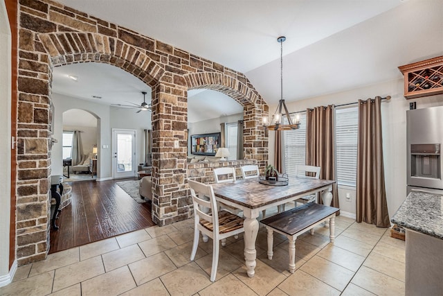 4818 Connor Dr, Baytown, TX 77521 - dining area with arched walkways, a chandelier, light tile patterned floors, a ceiling fan, and baseboards