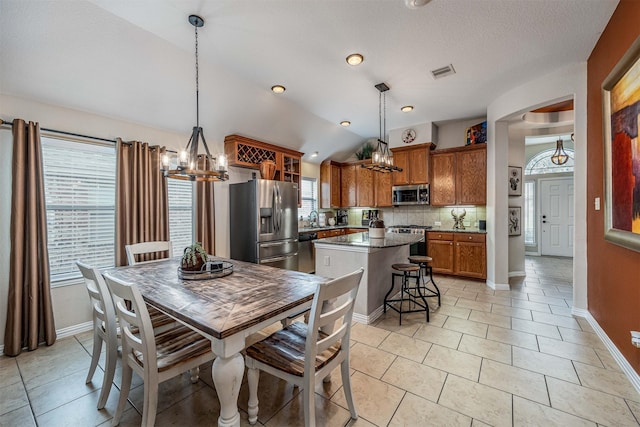 4818 Connor Dr, Baytown, TX 77521 - dining space featuring a chandelier, baseboards, light tile patterned floors, lofted ceiling, and a textured ceiling