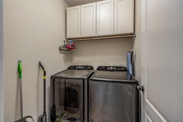 4818 Connor Dr, Baytown, TX 77521 - clothes washing area featuring washer and clothes dryer, cabinet space, and a textured wall