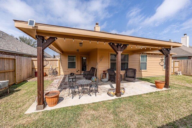 4818 Connor Dr, Baytown, TX 77521 - back of house with a chimney and a patio area