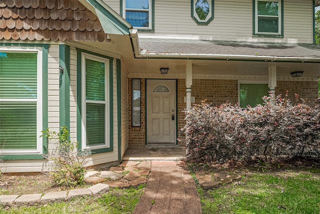 5118 Forest Trl, Baytown, TX 77521 - entrance to property featuring roof with shingles, brick siding, and covered porch