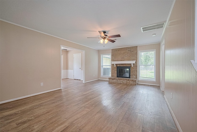 5118 Forest Trl, Baytown, TX 77521 - unfurnished living room with a ceiling fan, wood finished floors, a brick fireplace, crown molding, and baseboards