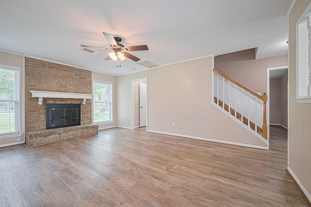 5118 Forest Trl, Baytown, TX 77521 - unfurnished living room featuring wood finished floors, ceiling fan, stairs, baseboards, and a fireplace