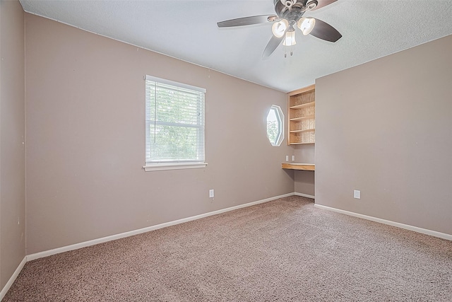 5118 Forest Trl, Baytown, TX 77521 - unfurnished room featuring carpet flooring, ceiling fan, baseboards, built in features, and built in study area