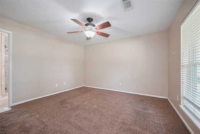 5118 Forest Trl, Baytown, TX 77521 - empty room with carpet, ceiling fan, healthy amount of natural light, and a textured ceiling