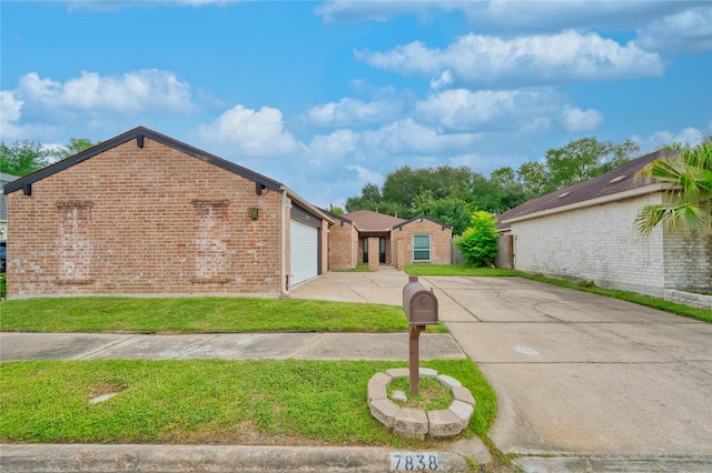7838 Vickijohn Dr, Houston, TX 77071 - view of front of house with concrete driveway, brick siding, a front yard, and a garage
