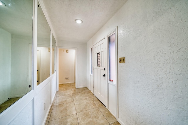 7838 Vickijohn Dr, Houston, TX 77071 - hall with a textured wall, light tile patterned floors, and a textured ceiling