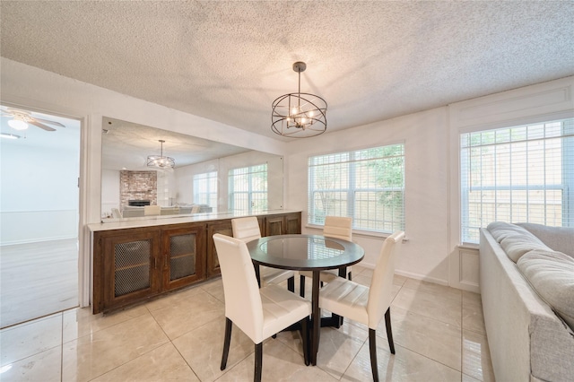 7838 Vickijohn Dr, Houston, TX 77071 - dining area featuring a chandelier, light tile patterned floors, a textured ceiling, and baseboards