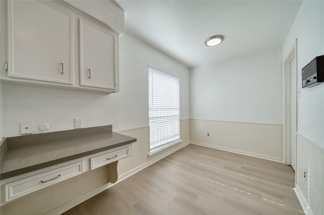 7838 Vickijohn Dr, Houston, TX 77071 - unfurnished dining area featuring wainscoting and light wood-type flooring