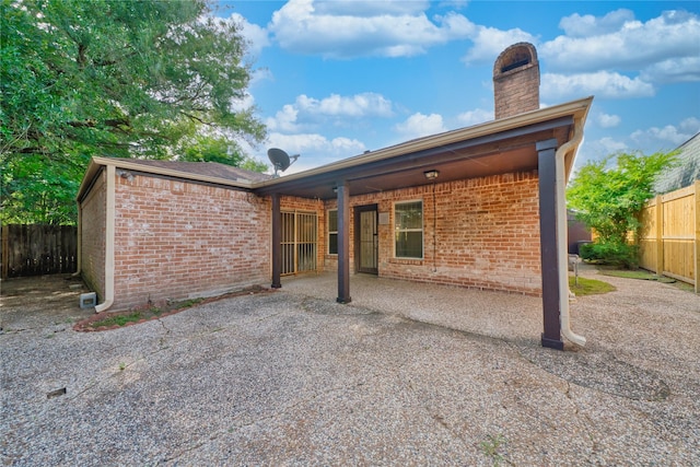 7838 Vickijohn Dr, Houston, TX 77071 - rear view of property with a chimney, brick siding, and a patio area