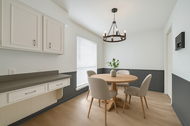 7838 Vickijohn Dr, Houston, TX 77071 - dining area featuring wainscoting, a chandelier, and light wood-type flooring