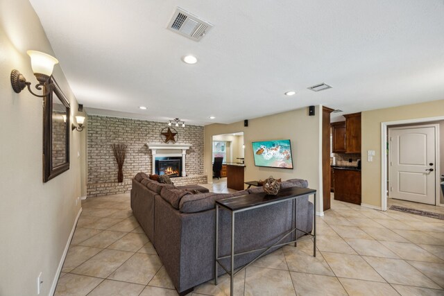 233 Magnolia Way, Huntsville, TX 77320 - living area with light tile patterned floors, a fireplace, baseboards, brick wall, and recessed lighting