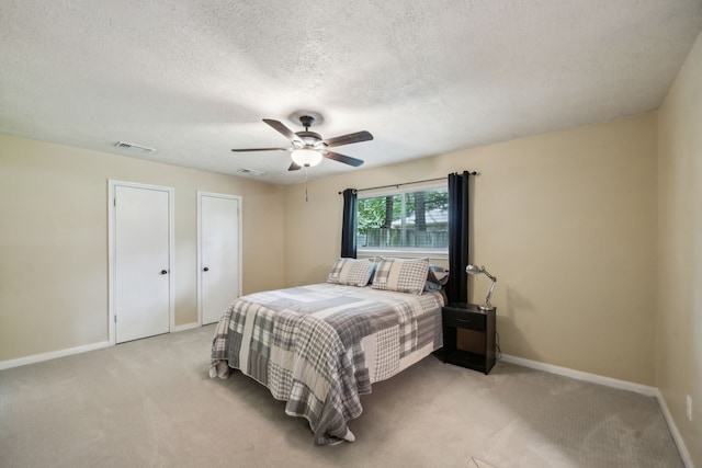 233 Magnolia Way, Huntsville, TX 77320 - bedroom with light carpet, baseboards, a ceiling fan, and a textured ceiling