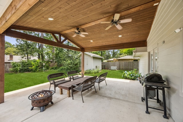 233 Magnolia Way, Huntsville, TX 77320 - view of patio / terrace with an outdoor fire pit, a storage shed, ceiling fan, and an outbuilding