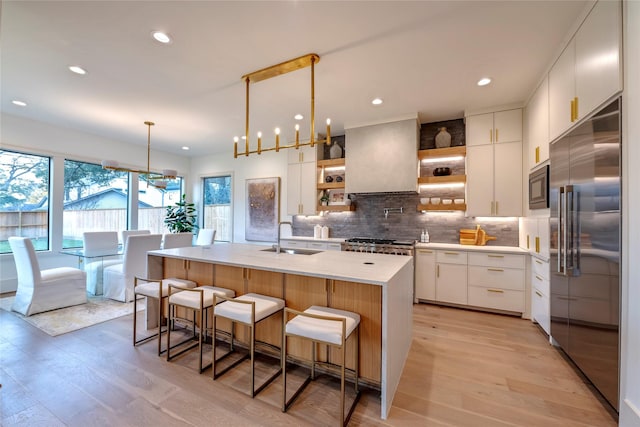 1322 Candlelight Ln, Houston, TX 77018 - kitchen with built in appliances, a sink, open shelves, light wood finished floors, and light countertops