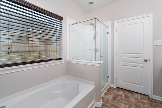 213 Splintered Arrow Dr, La Marque, TX 77568 - full bath featuring a shower stall, a garden tub, and stone finish flooring