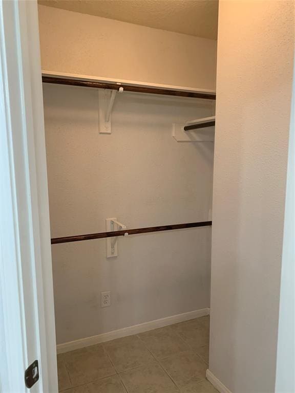 10702 Allens Landing Dr, Houston, TX 77065 - spacious closet featuring light tile patterned floors