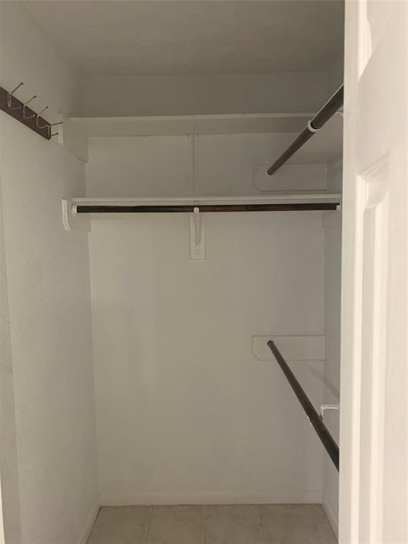 10702 Allens Landing Dr, Houston, TX 77065 - walk in closet with light tile patterned flooring