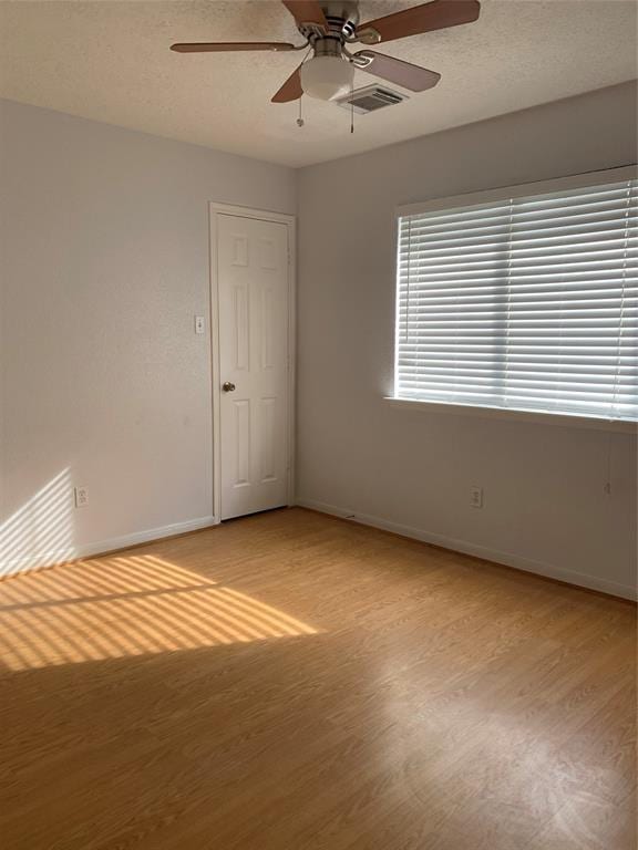 10702 Allens Landing Dr, Houston, TX 77065 - spare room featuring light wood-style floors, baseboards, and ceiling fan