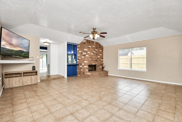 1207 Martingale Ct, Crosby, TX 77532 - unfurnished living room featuring light tile patterned floors, ceiling fan, a brick fireplace, healthy amount of natural light, and vaulted ceiling