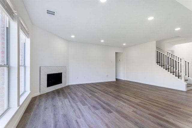 21511 Pepperberry Trl, Spring, TX 77388 - unfurnished living room featuring wood finished floors, recessed lighting, stairs, a fireplace, and baseboards