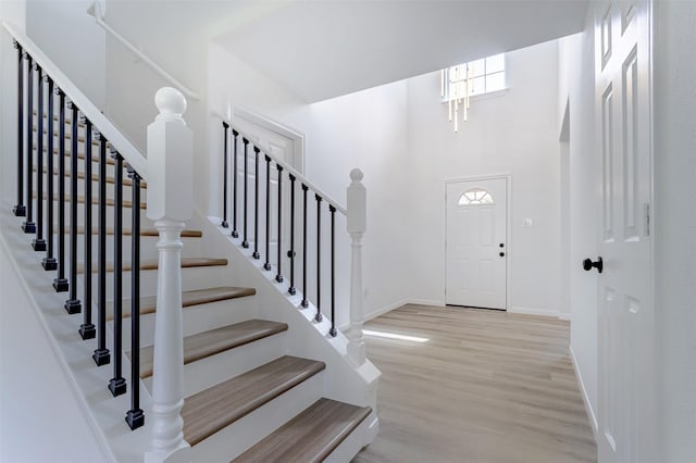 21511 Pepperberry Trl, Spring, TX 77388 - foyer entrance featuring wood finished floors, baseboards, stairs, and a towering ceiling