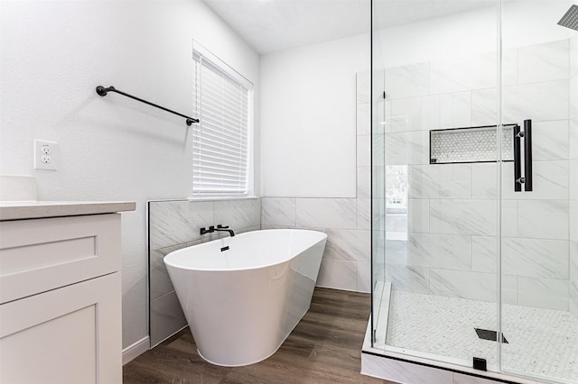 21511 Pepperberry Trl, Spring, TX 77388 - bathroom with a freestanding bath, a stall shower, wood finished floors, and vanity