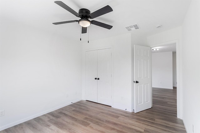 21511 Pepperberry Trl, Spring, TX 77388 - unfurnished bedroom featuring wood finished floors, a closet, and baseboards