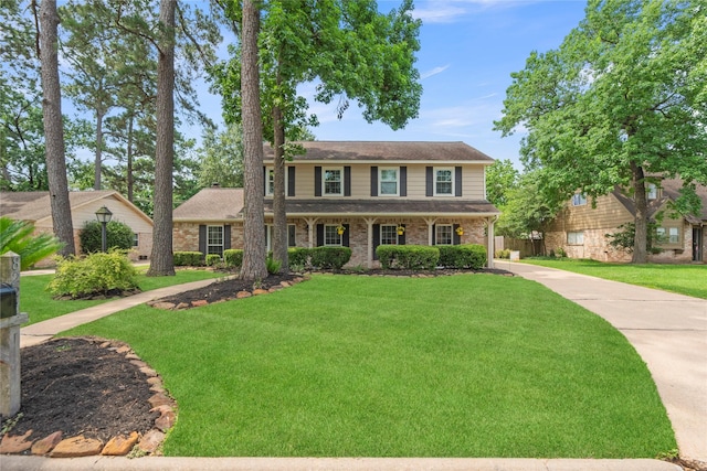 8223 Bairnsdale Ln, Houston, TX 77070 - colonial house with a front yard and brick siding