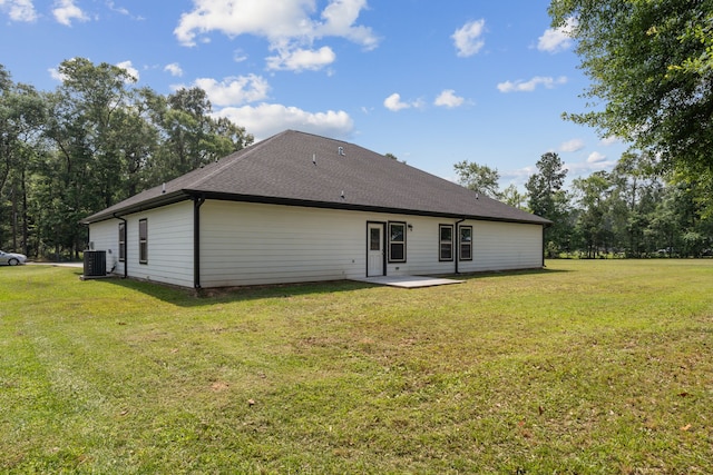 69 County Road 3668, Splendora, TX 77372 - back of property featuring a yard, a patio, and central AC unit