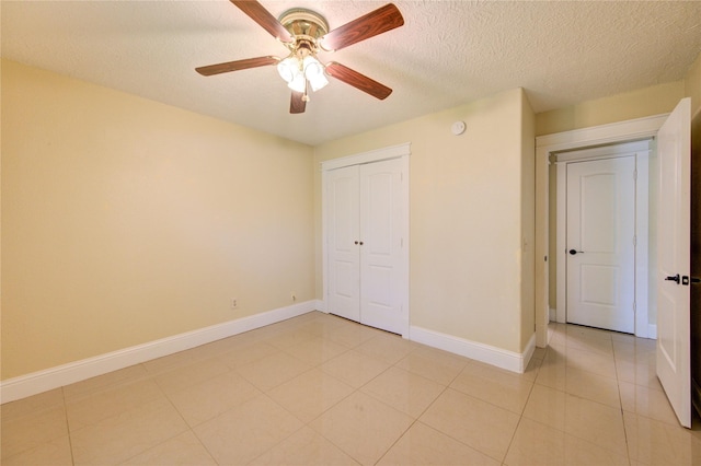 2815 Lakefield Way, Sugar Land, TX 77479 - unfurnished bedroom with a closet, baseboards, a ceiling fan, a textured ceiling, and light tile patterned flooring