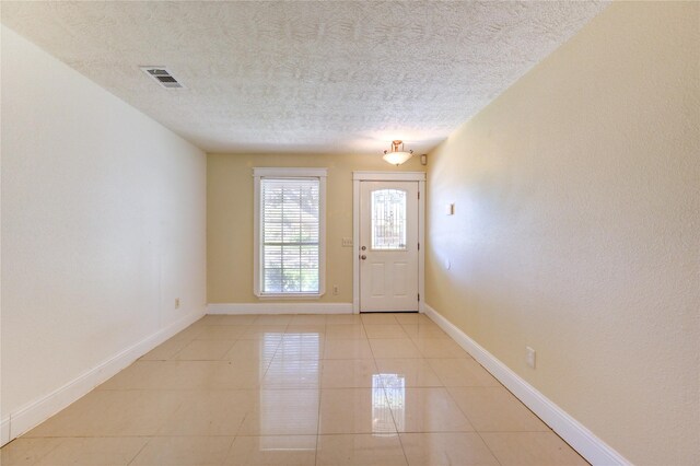 2815 Lakefield Way, Sugar Land, TX 77479 - foyer featuring a textured ceiling, light tile patterned floors, and baseboards