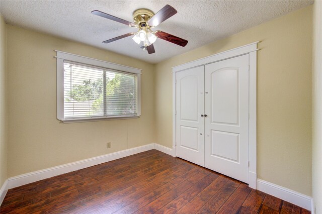 2815 Lakefield Way, Sugar Land, TX 77479 - unfurnished bedroom featuring dark wood-style flooring, baseboards, a textured ceiling, a closet, and a ceiling fan